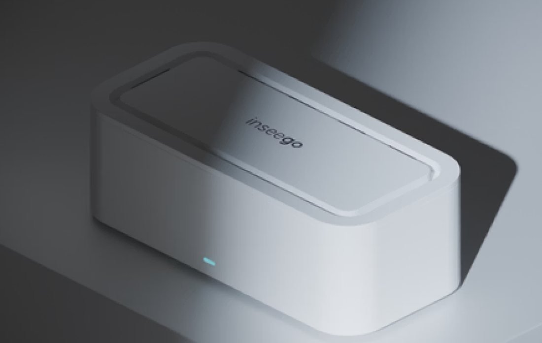 The Inseego 5G router seen from above at an angle: a compact white box with a recessed lid and a small status light.